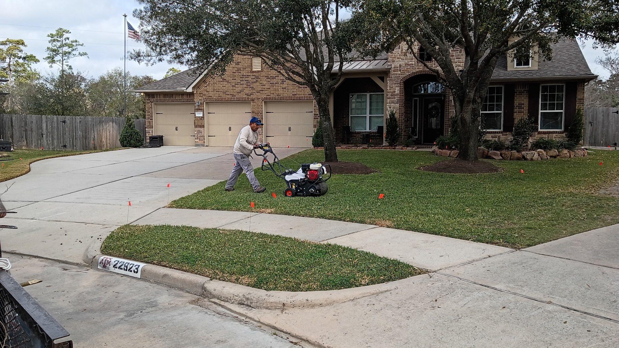 Professional core lawn aeration service on a residential property in Spring, TX