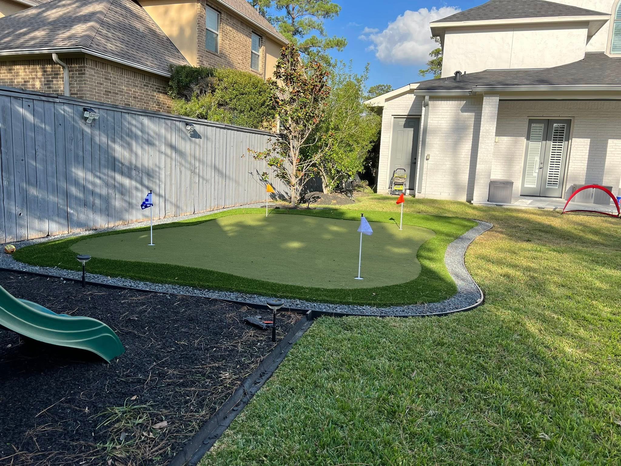 Custom artificial turf and backyard putting green installation in The Woodlands, TX